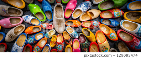 Set of different colorful vintage Dutch wooden clogs 129095474