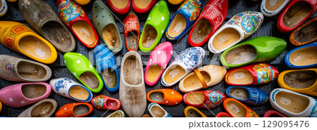 Set of different colorful vintage Dutch wooden clogs 129095476