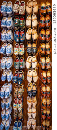 Set of different colorful vintage Dutch wooden clogs 129095489