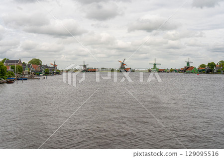 Rural landscape with windmill in Zaanse Schans. Holland, Netherlands. Authentic Zaandam mill. Beautiful Netherland landscape. Rural landscape with windmill in Zaanse Schans. Holland, Netherlands. Authentic Zaandam mill. Beautiful Netherland landscape. 129095516