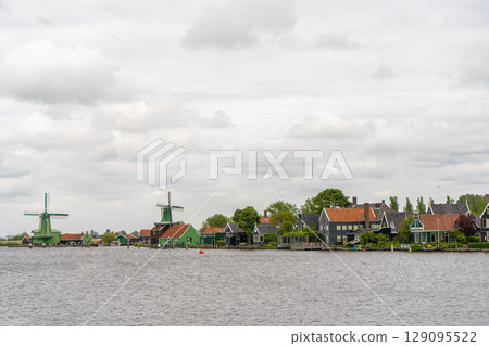 Rural landscape with windmill in Zaanse Schans. Holland, Netherlands. Authentic Zaandam mill. Beautiful Netherland landscape. Rural landscape with windmill in Zaanse Schans. Holland, Netherlands. Authentic Zaandam mill. Beautiful Netherland landscape. 129095522