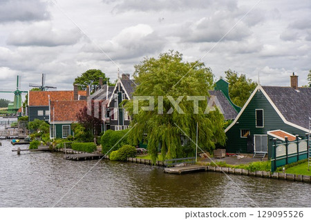 Rural landscape with windmill in Zaanse Schans. Holland, Netherlands. Authentic Zaandam mill. Beautiful Netherland landscape. Rural landscape with windmill in Zaanse Schans. Holland, Netherlands. Authentic Zaandam mill. Beautiful Netherland landscape. 129095526
