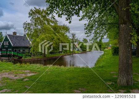 Rural landscape with windmill in Zaanse Schans. Holland, Netherlands. Authentic Zaandam mill. Beautiful Netherland landscape. Rural landscape with windmill in Zaanse Schans. Holland, Netherlands. Authentic Zaandam mill. Beautiful Netherland landscape. 129095528
