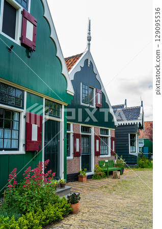 Authentic Zaandam mills on the water channel in Zaanse Schans willage. Zaanse Schans Windmills and famous Netherlands canals, Europe. 129095536
