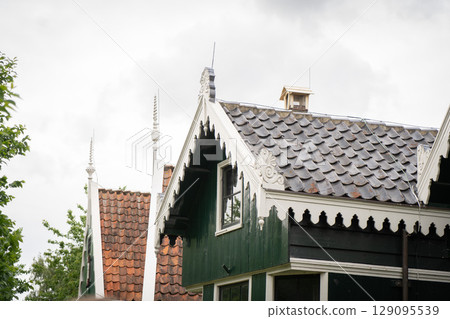 Authentic Zaandam mills on the water channel in Zaanse Schans willage. Zaanse Schans Windmills and famous Netherlands canals, Europe. Authentic Zaandam mills on the water channel in Zaanse Schans willage. Zaanse Schans Windmills and famous Netherlands canals, Europe. 129095539