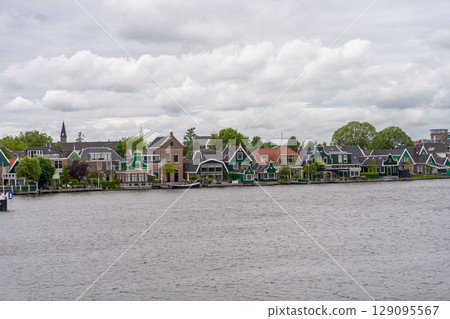 Rural landscape with windmill in Zaanse Schans. Holland, Netherlands. Authentic Zaandam mill. Beautiful Netherland landscape. 129095567
