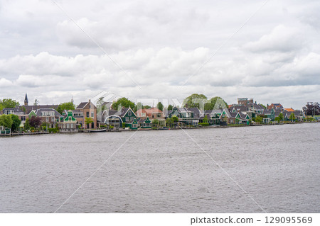 Rural landscape with windmill in Zaanse Schans. Holland, Netherlands. Authentic Zaandam mill. Beautiful Netherland landscape. Rural landscape with windmill in Zaanse Schans. Holland, Netherlands. Authentic Zaandam mill. Beautiful Netherland landscape. 129095569