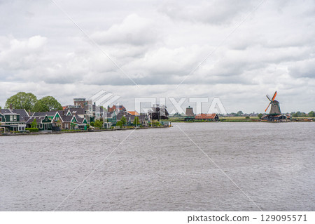 Rural landscape with windmill in Zaanse Schans. Holland, Netherlands. Authentic Zaandam mill. Beautiful Netherland landscape. Rural landscape with windmill in Zaanse Schans. Holland, Netherlands. Authentic Zaandam mill. Beautiful Netherland landscape. 129095571