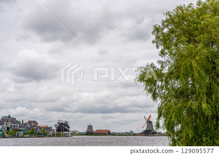 Rural landscape with windmill in Zaanse Schans. Holland, Netherlands. Authentic Zaandam mill. Beautiful Netherland landscape. Rural landscape with windmill in Zaanse Schans. Holland, Netherlands. Authentic Zaandam mill. Beautiful Netherland landscape. 129095577