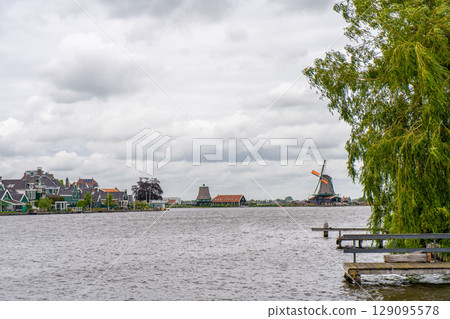 Rural landscape with windmill in Zaanse Schans. Holland, Netherlands. Authentic Zaandam mill. Beautiful Netherland landscape. 129095578