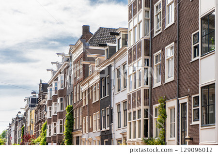 Details and facades of Amsterdam characteristic brick construction of residential building in Amsterdam School style. High quality photo 129096012
