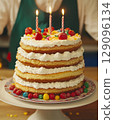 Birthday cake with colorful candles and candies close-up 129096134