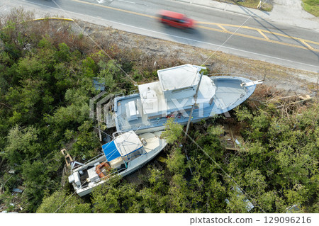 Capsized yachts left forsaken on shore after hurricane Milton on Manasota Key in Englewood, Florida 129096216