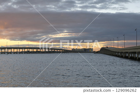 Barron Collier Bridge and Gilchrist Bridge in Florida with moving traffic. Transportation infrastructure in Charlotte County connecting Punta Gorda and Port Charlotte over Peace River 129096262