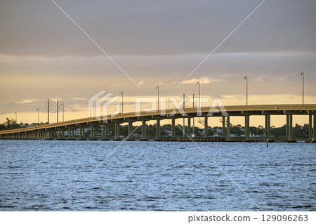 Barron Collier Bridge and Gilchrist Bridge in Florida with moving traffic. Transportation infrastructure in Charlotte County connecting Punta Gorda and Port Charlotte over Peace River 129096263