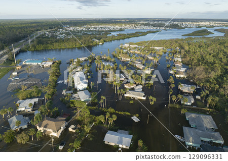 Aftermath of natural disaster. Surrounded by hurricane rainfall flood waters homes in Florida residential area Aftermath of natural disaster. Surrounded by hurricane rainfall flood waters homes in Florida residential area 129096331