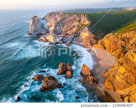 Ursa Beach, Cliffs and Atlantic Ocean Waves at Sunset. Portugal. Aerial View 129096407