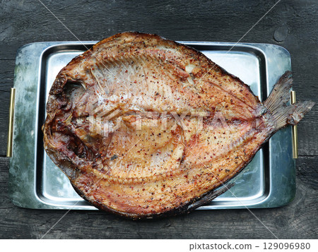 Golden smoked river bream on dark background, top view Golden smoked river bream on dark background, top view 129096980