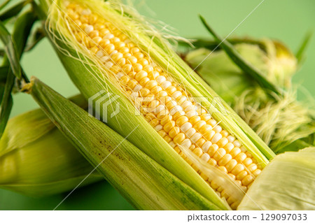 organic sweet corn in green husk on background 129097033
