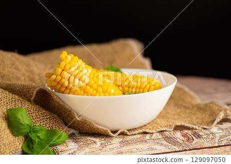 close-up of juicy corn in a white plate 129097050