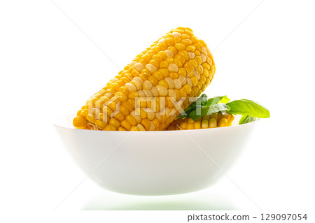 large boiled corn isolated on a white background 129097054