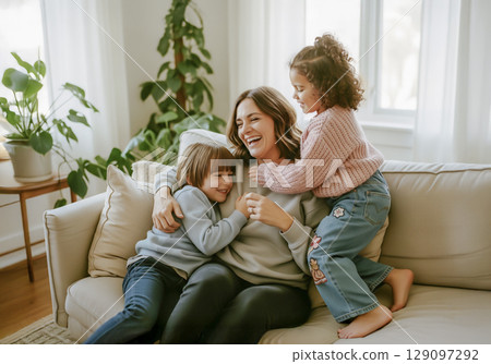 Happy Mother Cuddling with Her Children on a Sunlit Sofa. AI generated 129097292