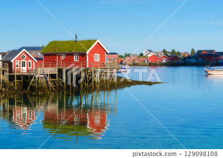 View of a traditional house with moss on the roof in the Lofoten Islands, Norway. 129098108