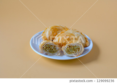 Thai Curry puff,puff pastry stuffed chicken on plate. 129099236