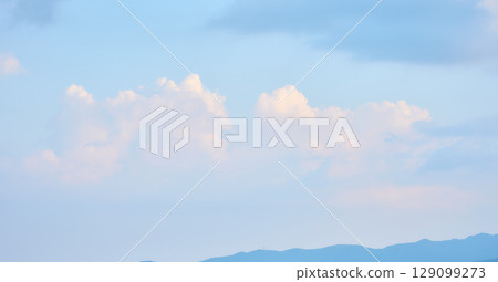 Clouds faintly illuminated by the setting sun Clouds faintly illuminated by the setting sun 129099273