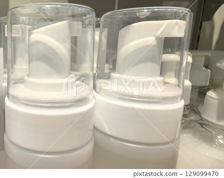 Modern pump dispensers lined up for an organized display in a store setting 129099470