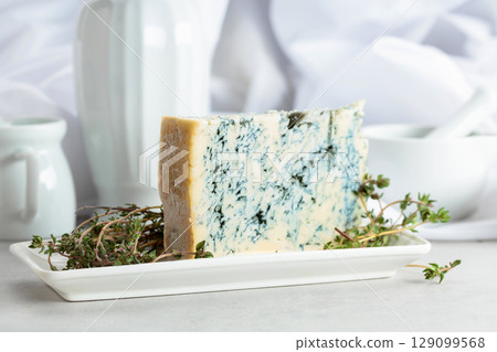 Gorgonzola and thyme on a white table. 129099568