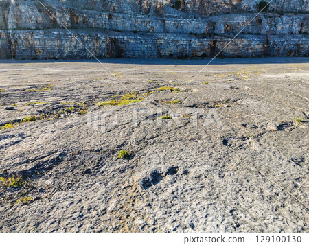 Natural monument of fossil dinosaur footprints in Portugal. Pedagogical circuit and visitors can see and touch the footprints 129100130