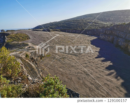 Natural monument of fossil dinosaur footprints in Portugal. Pedagogical circuit and visitors can see and touch the footprints 129100157