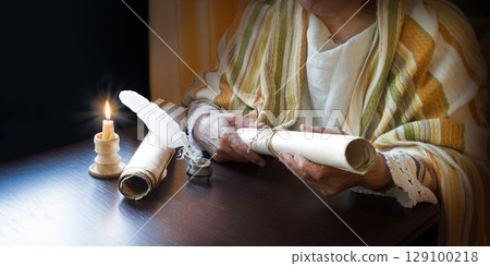 Man holding an old scroll Man holding an old scroll 129100218