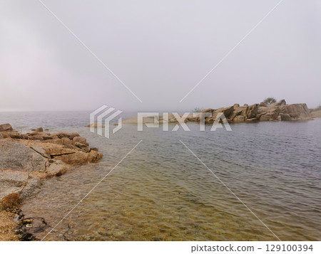 Idyllic landscape of a lagoon in a foggy environment, in Lagoa Comprida, Serra da Estrela, Portugal Idyllic landscape of a lagoon in a foggy environment, in Lagoa Comprida, Serra da Estrela, Portugal 129100394