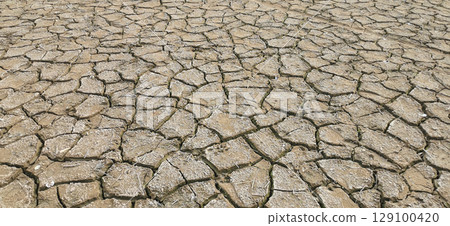 Dry riverbed, with arid and cracked soil because of drought, due to climate change 129100420