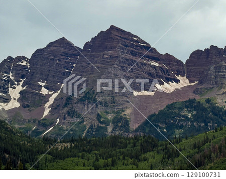 Maroon Bells Peaks in Summer with Snow Patches and Lush Forest Maroon Bells Peaks in Summer with Snow Patches and Lush Forest 129100731