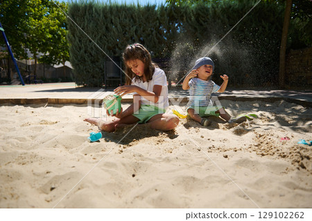 Children Enjoying Fun Activities Together Outdoors on a Sunny Day Children Enjoying Fun Activities Together Outdoors on a Sunny Day 129102262