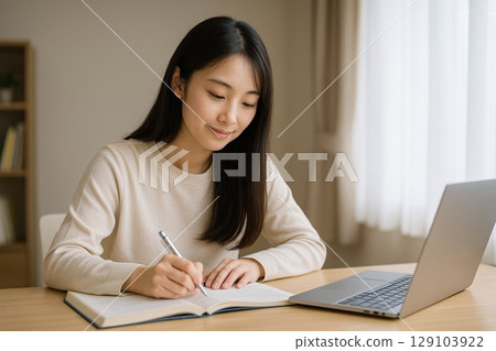 Young woman studying with books and 129103922