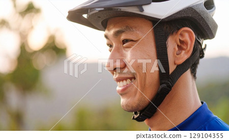 Man wearing a bicycle helmet Man wearing a bicycle helmet 129104355