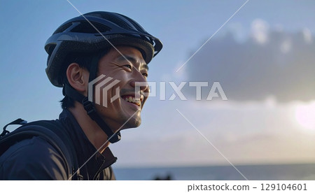 Man wearing a bicycle helmet 129104601