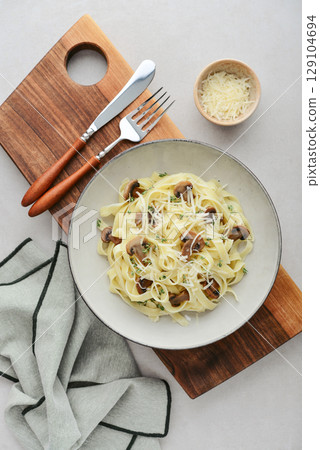 Mushroom pasta with cream parmesan cheese 129104694