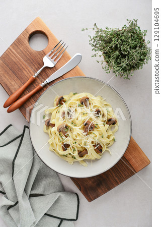 Mushroom pasta with cream parmesan cheese 129104695