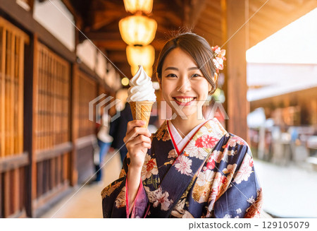 A young Japanese woman in a kimono holding a soft-serve ice cream A young Japanese woman in a kimono holding a soft-serve ice cream 129105079