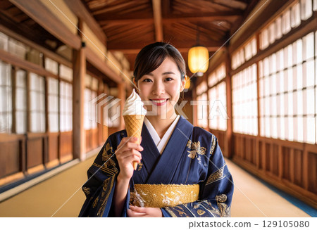 Young Japanese woman in a kimono holding a soft serve ice cream 129105080