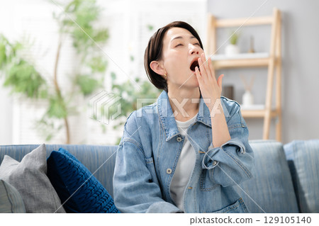 Sleepy woman in the living room 129105140