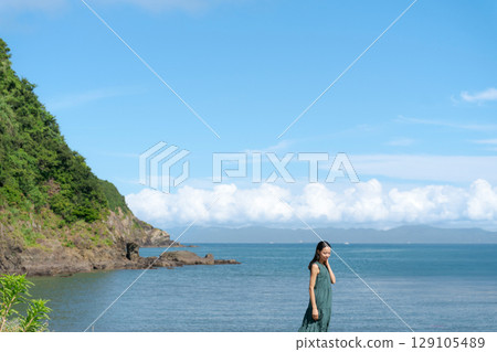 在沙灘上行走的年輕女子 在沙灘上行走的年輕女子 129105489