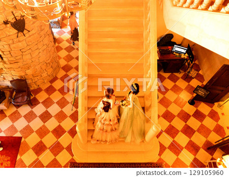 Young woman taking a photo on the stairs 129105960