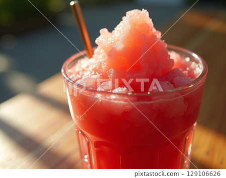 Strawberry Ice Slush in Vintage Glass with Natural Syrup Gradient on Sunlit Wooden Surface 129106626