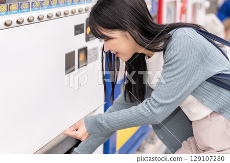 Young woman vending machine Young woman vending machine 129107280